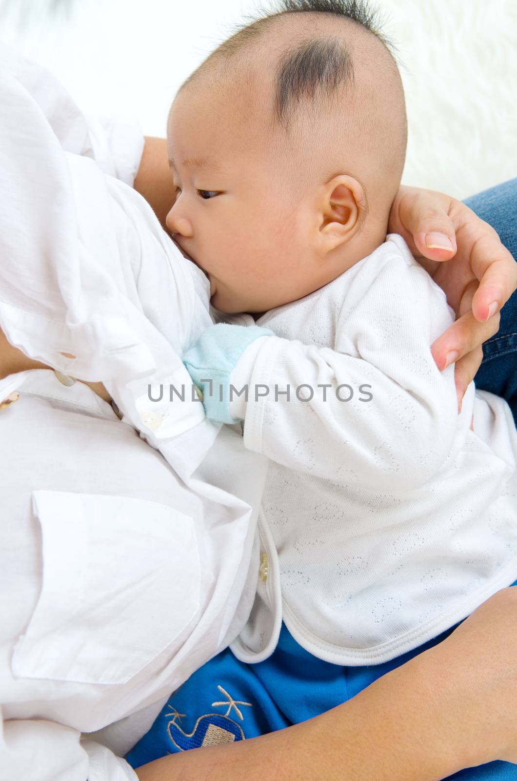 Asian mother breastfeeding her baby boy