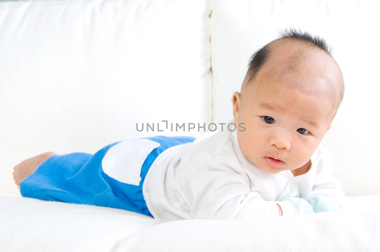 crawling beautiful baby boy on sofa