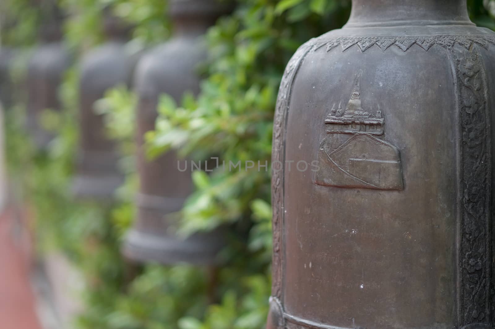 Close up bells of temple Golden Mountain with green leaves by eaglesky