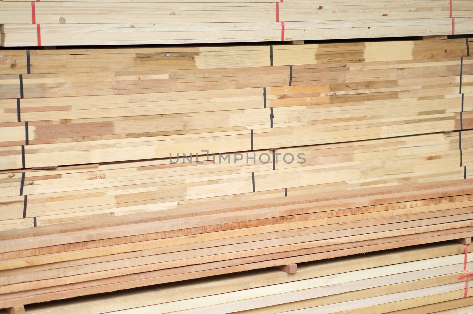 Stack of wood construction materials for building industry use as background.