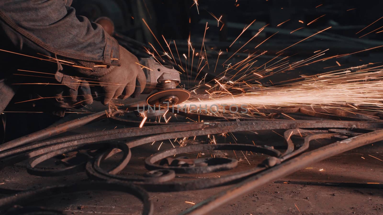 Close up of man's hands smoothing metal grate