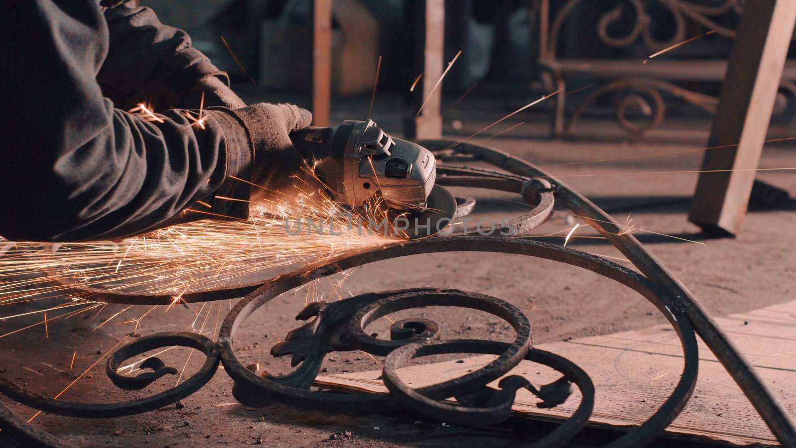 Close up of man's hands smoothing metal grate