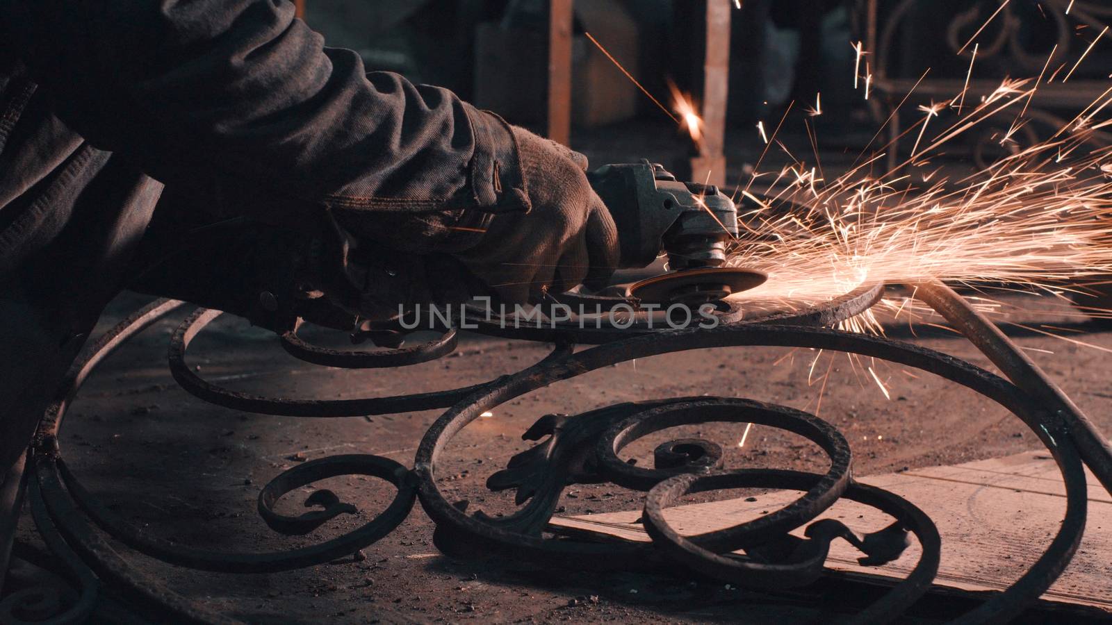 Close up of man's hands smoothing metal grate