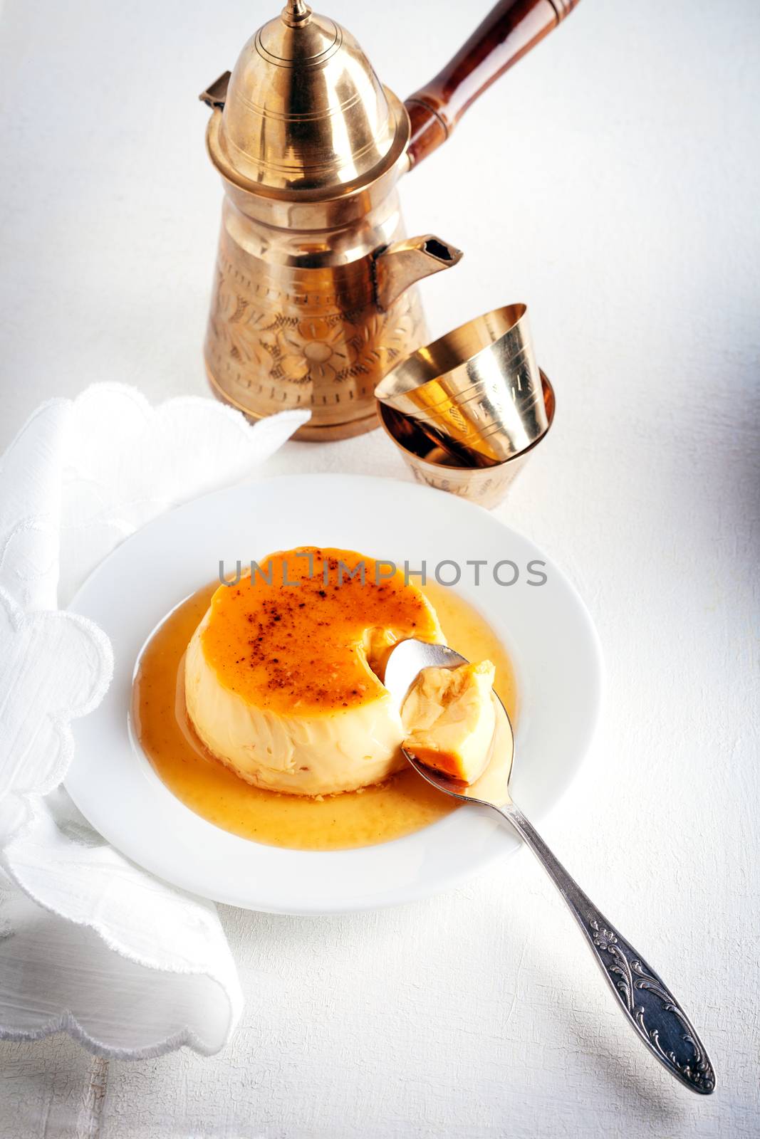 Homemade Creme Caramel with a spoon. Flan.