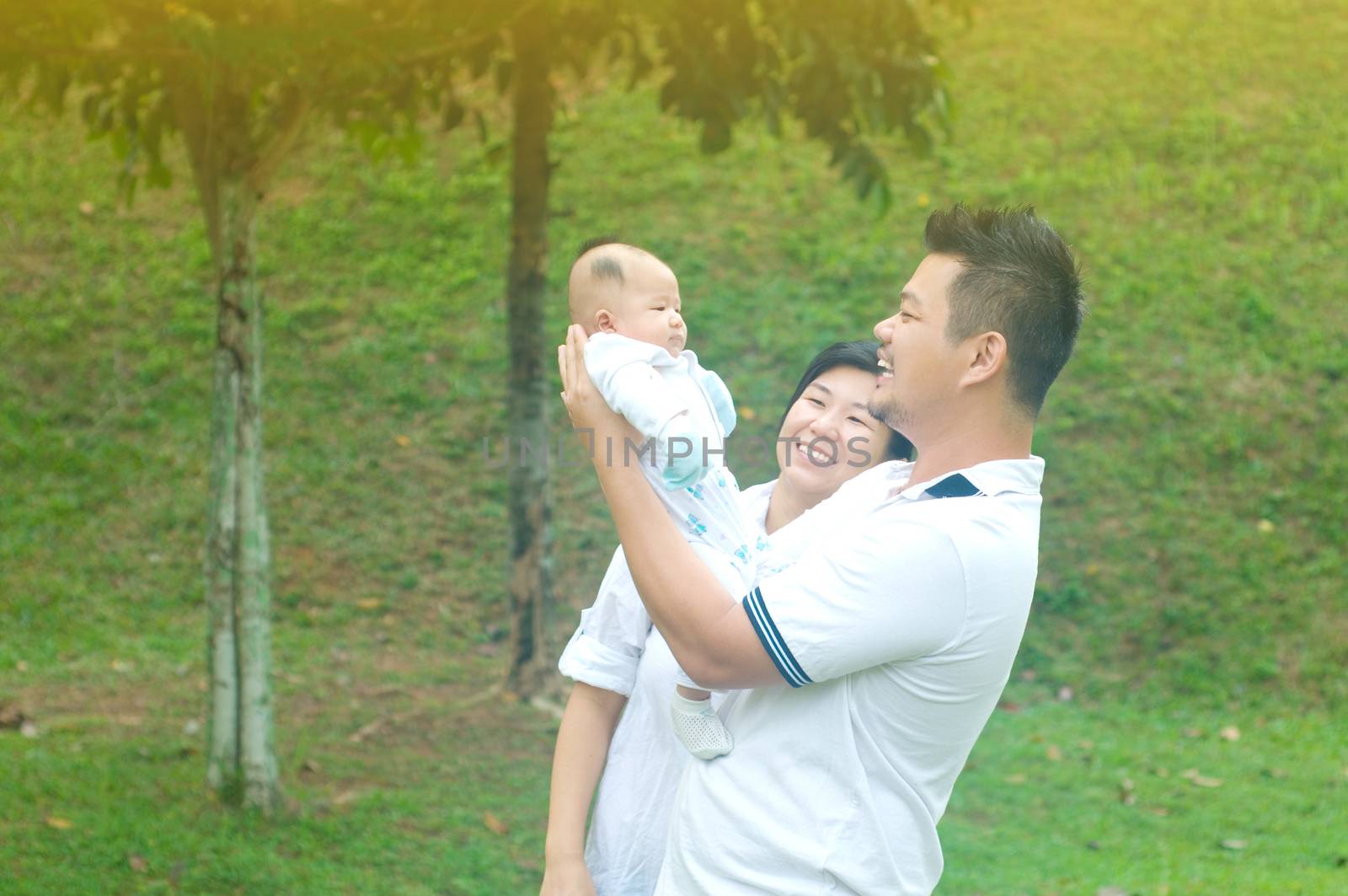 happy asian young family spending time outdoor on a summer day
