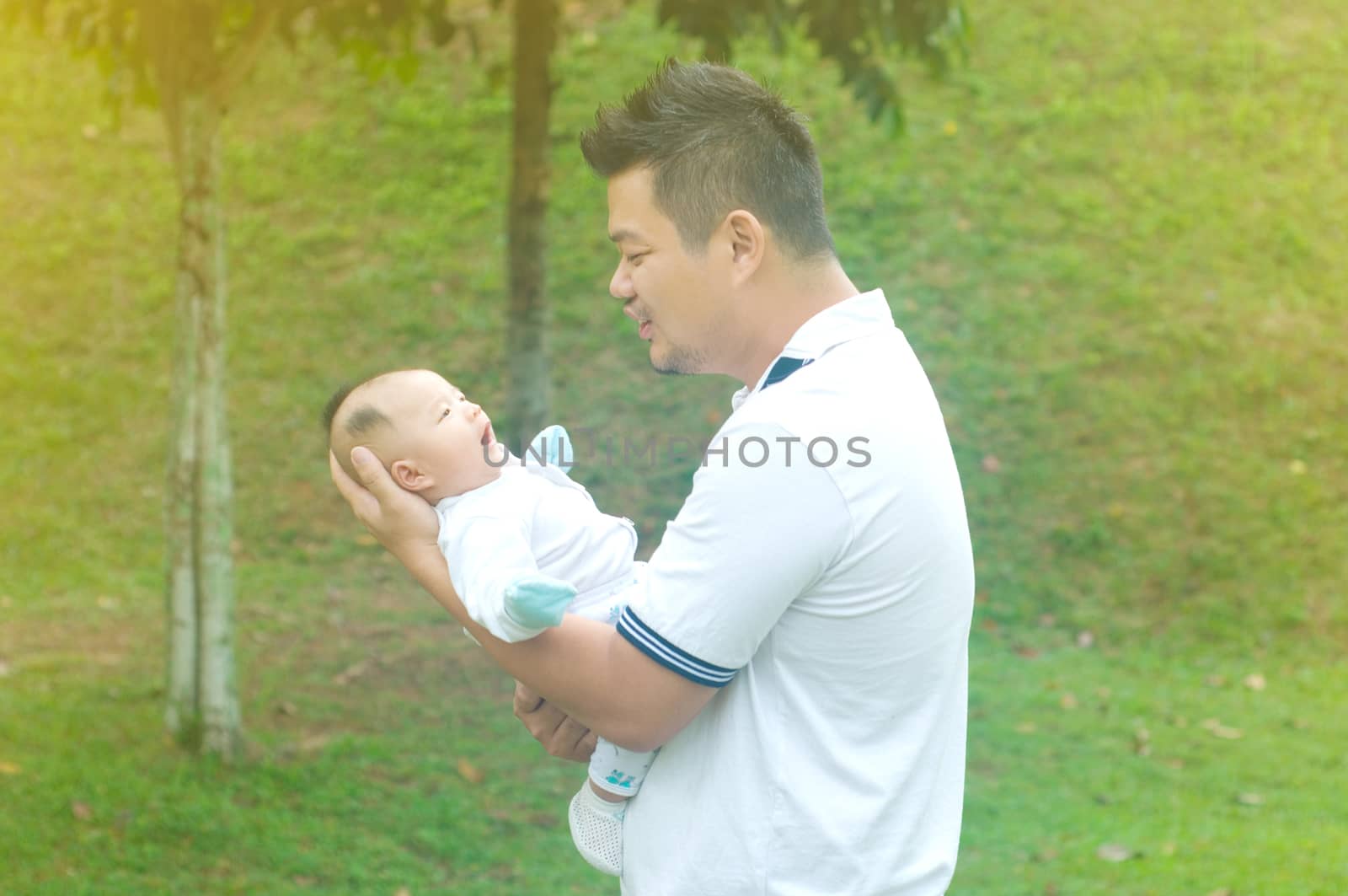 happy asian father and son spending time outdoor on a summer day