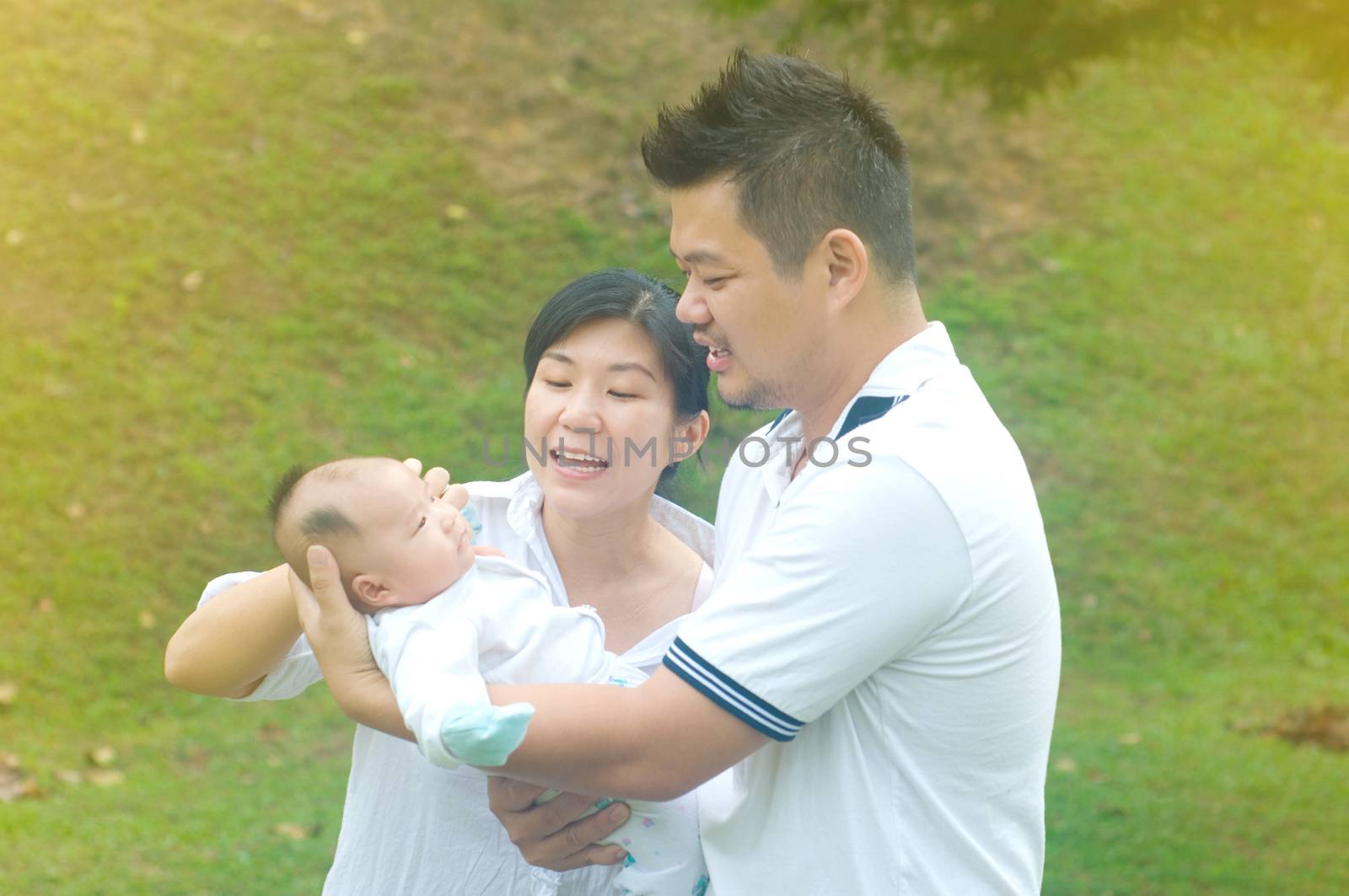 happy asian young family spending time outdoor on a summer day