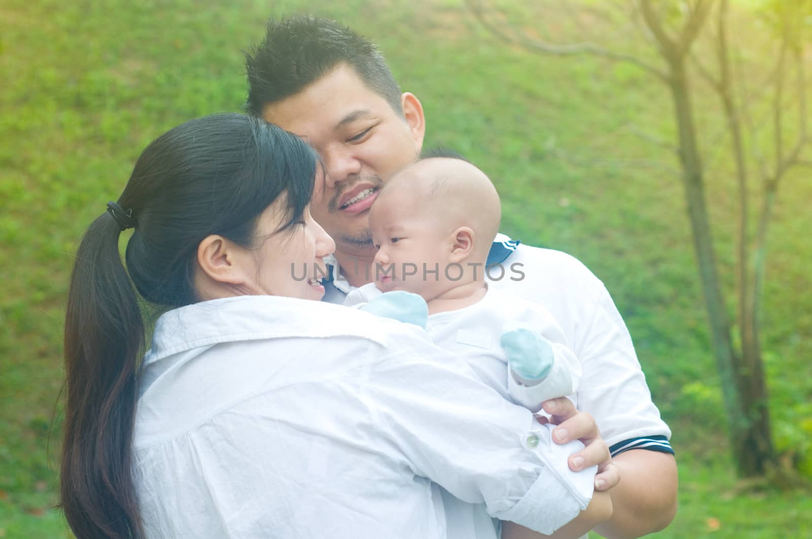 outdoor portrait of happy asian family