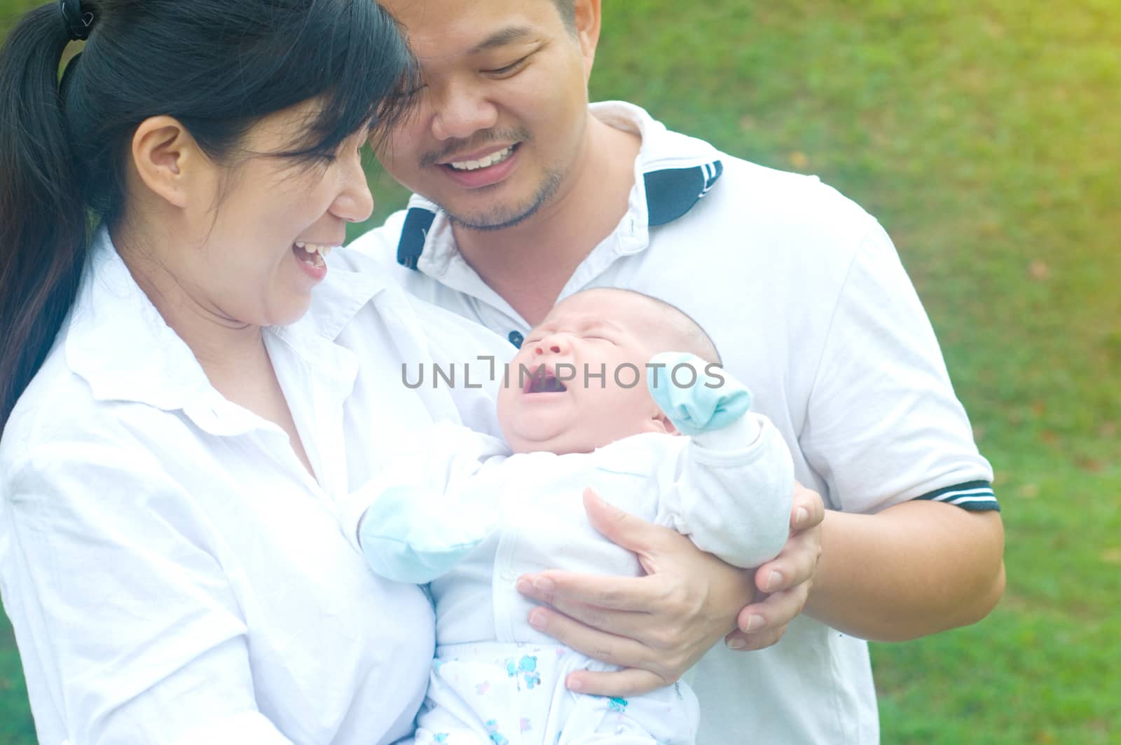 outdoor portrait of happy asian family