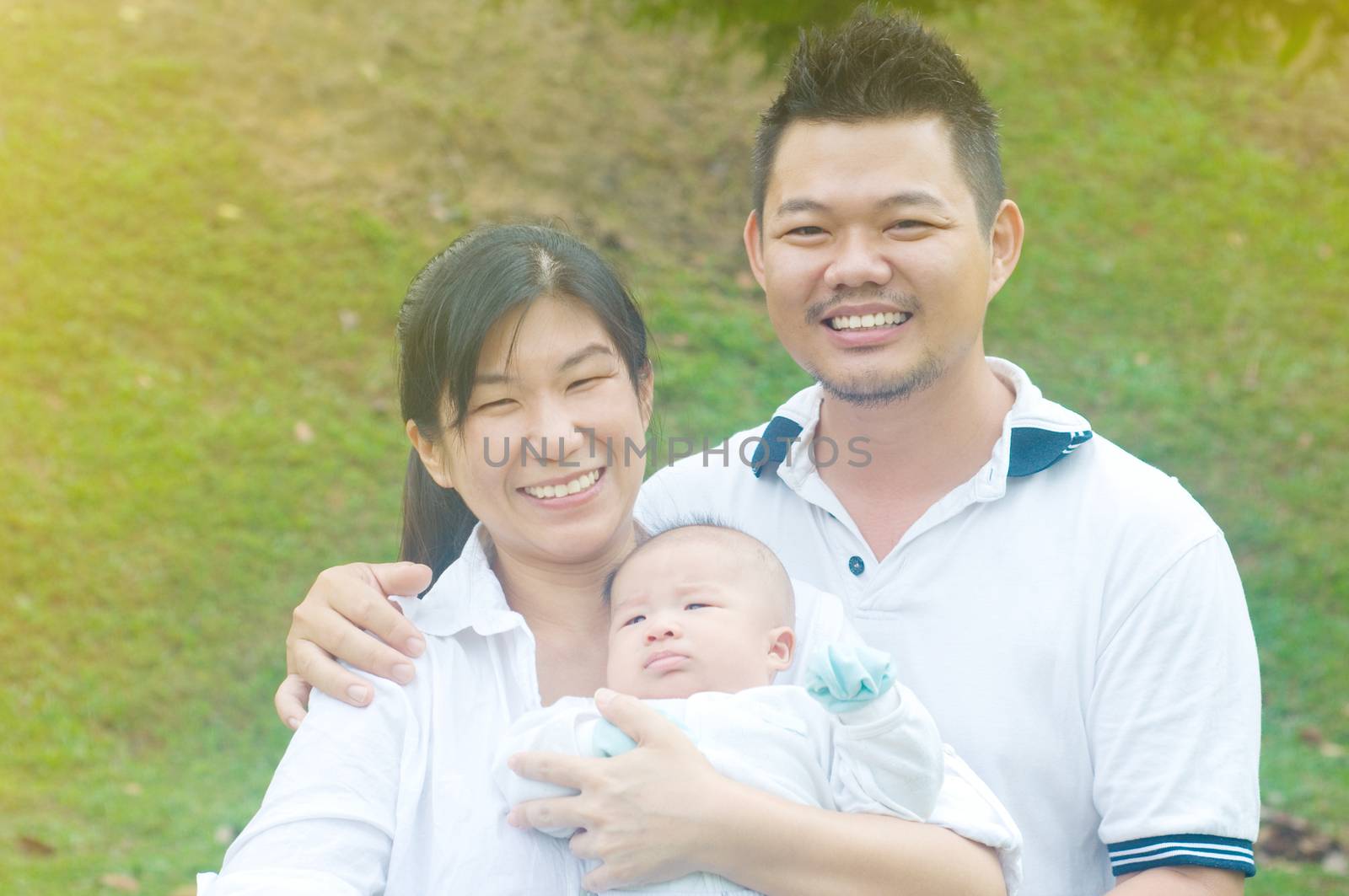 outdoor portrait of happy asian family