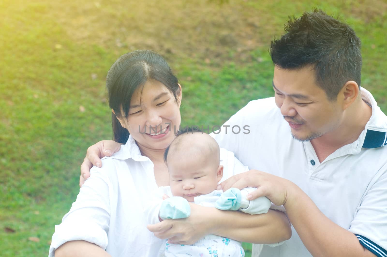 outdoor portrait of happy asian family