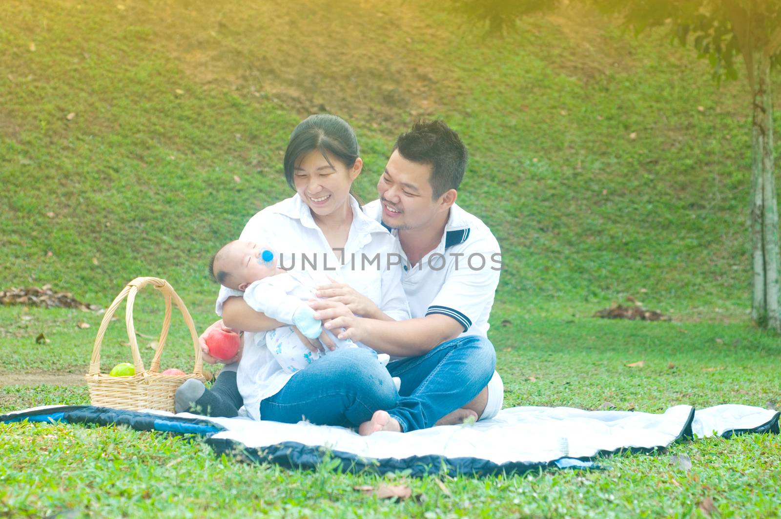 happy asian young family spending time outdoor on a summer day