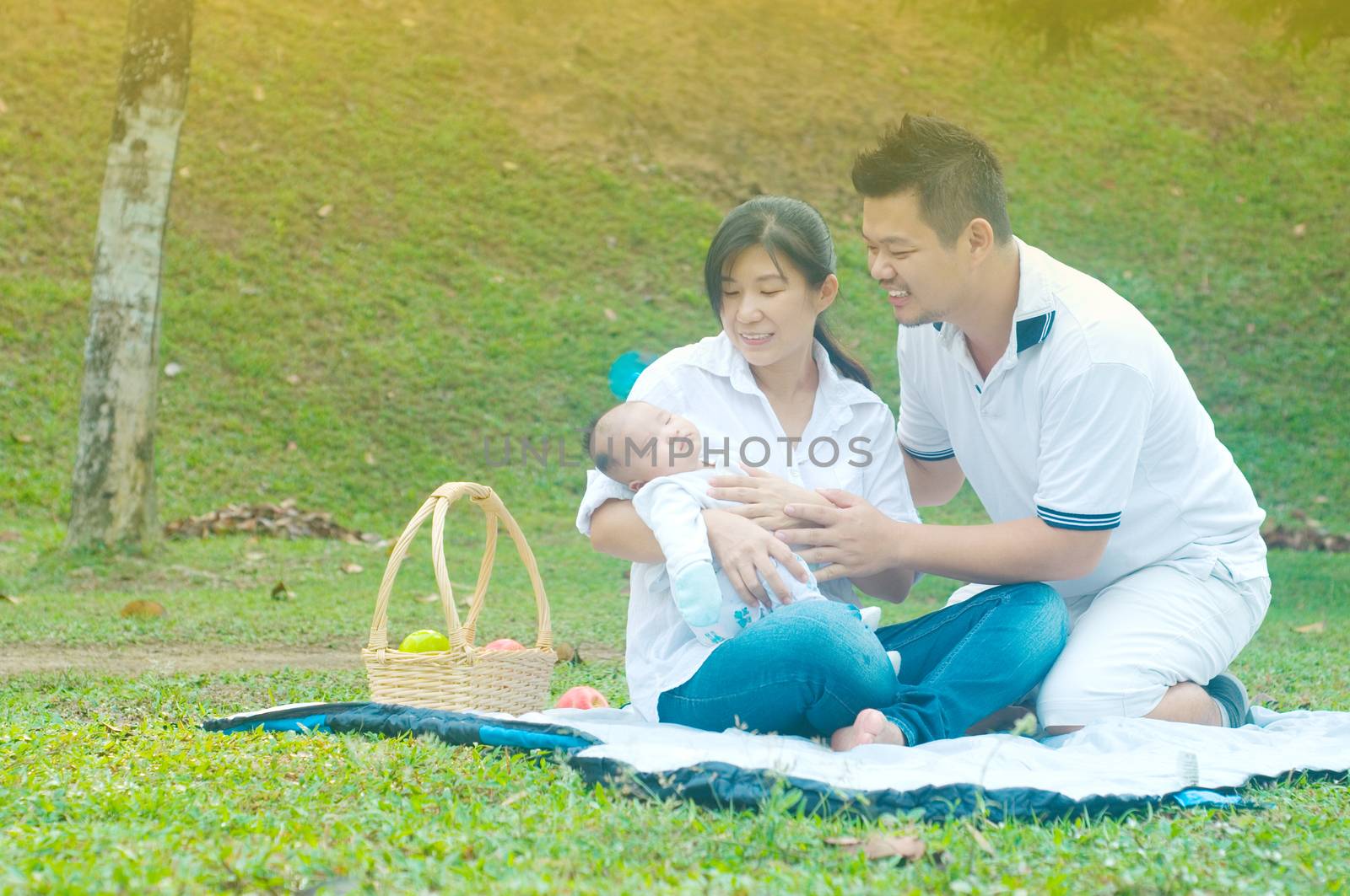 happy asian young family spending time outdoor on a summer day