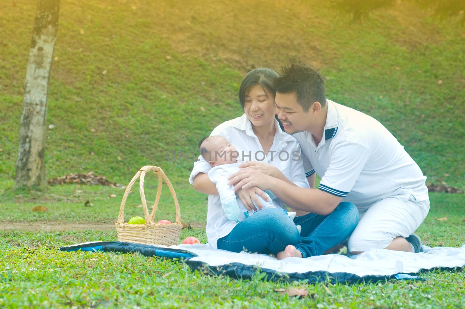 happy asian young family spending time outdoor on a summer day