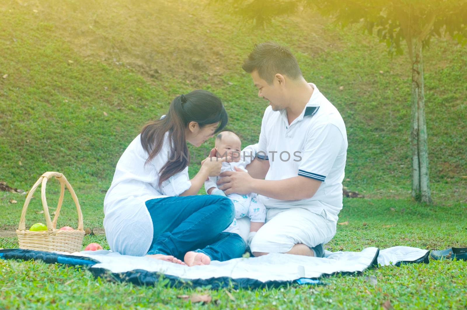 happy asian young family spending time outdoor on a summer day