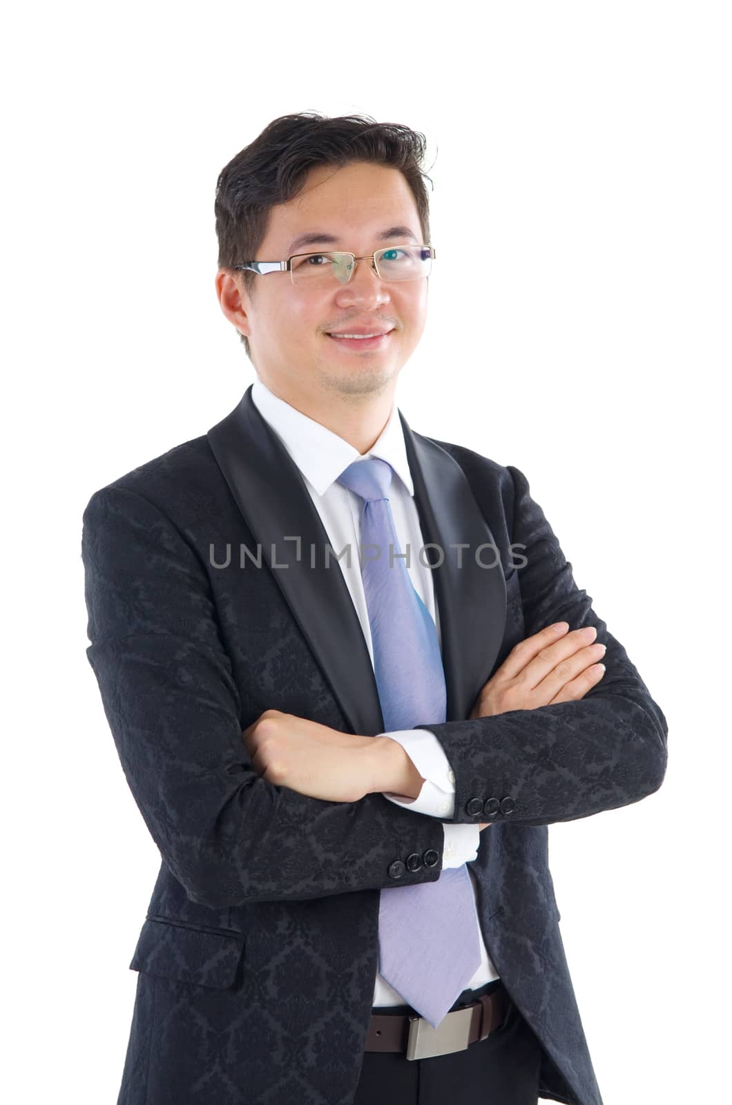 Confident Southeast Asian businessman crossed arms over white background