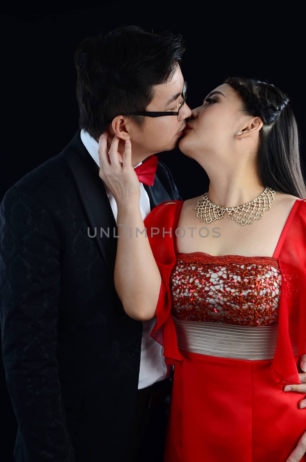 Attractive Bride and Groom at Wedding over black background