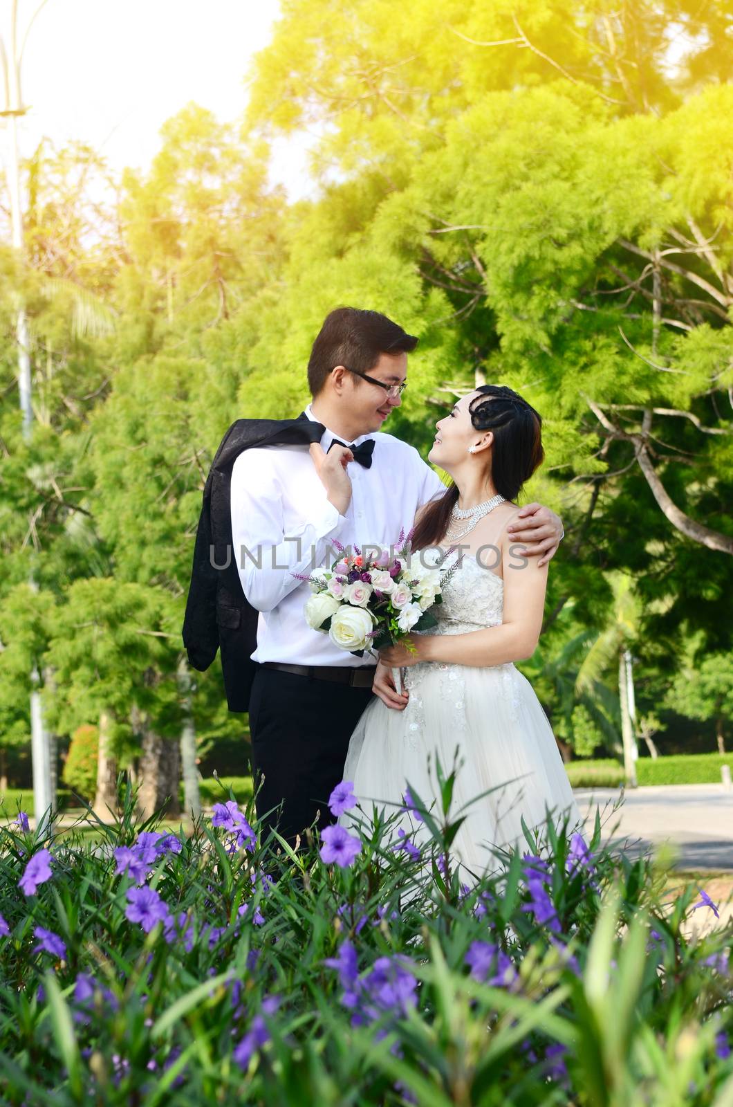 The asian couple embracing in the park