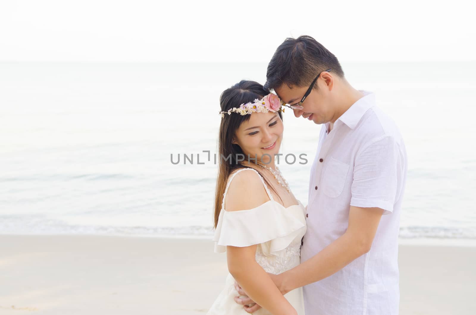 Outdoor Bride and groom on the beach in the evening.