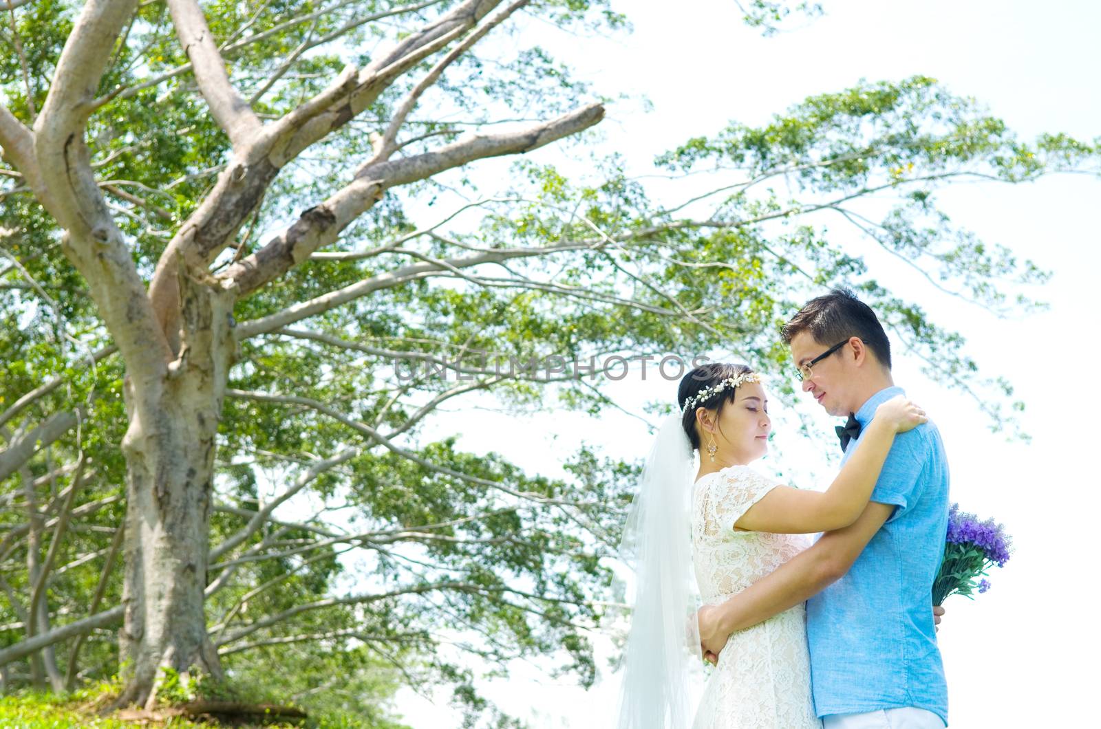 The asian couple embracing in the park