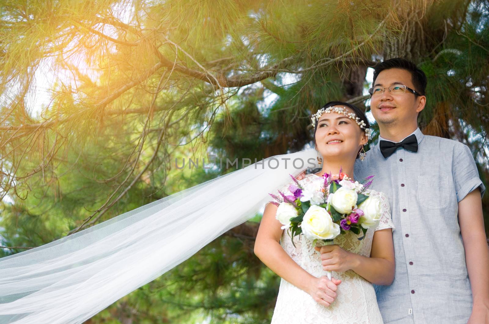 The asian couple embracing in the park