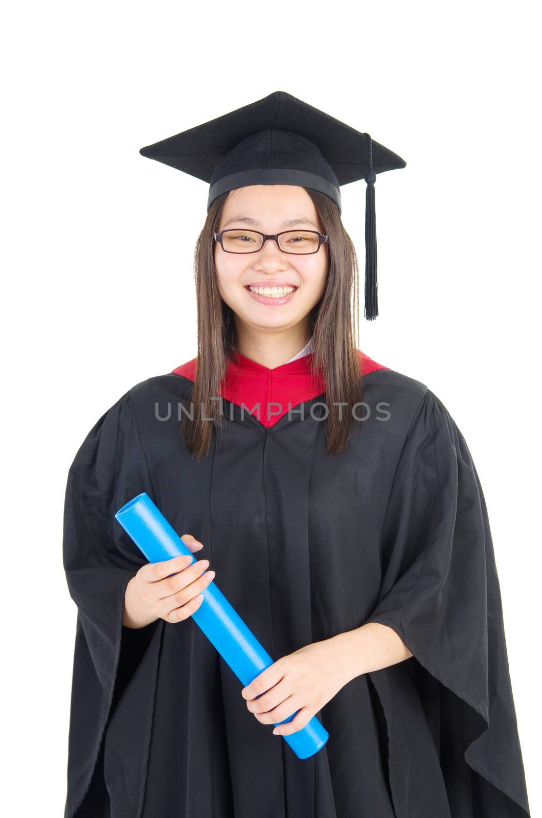 Happy university student in graduation gown and cap. Portrait of east Asian female model standing on plain background.