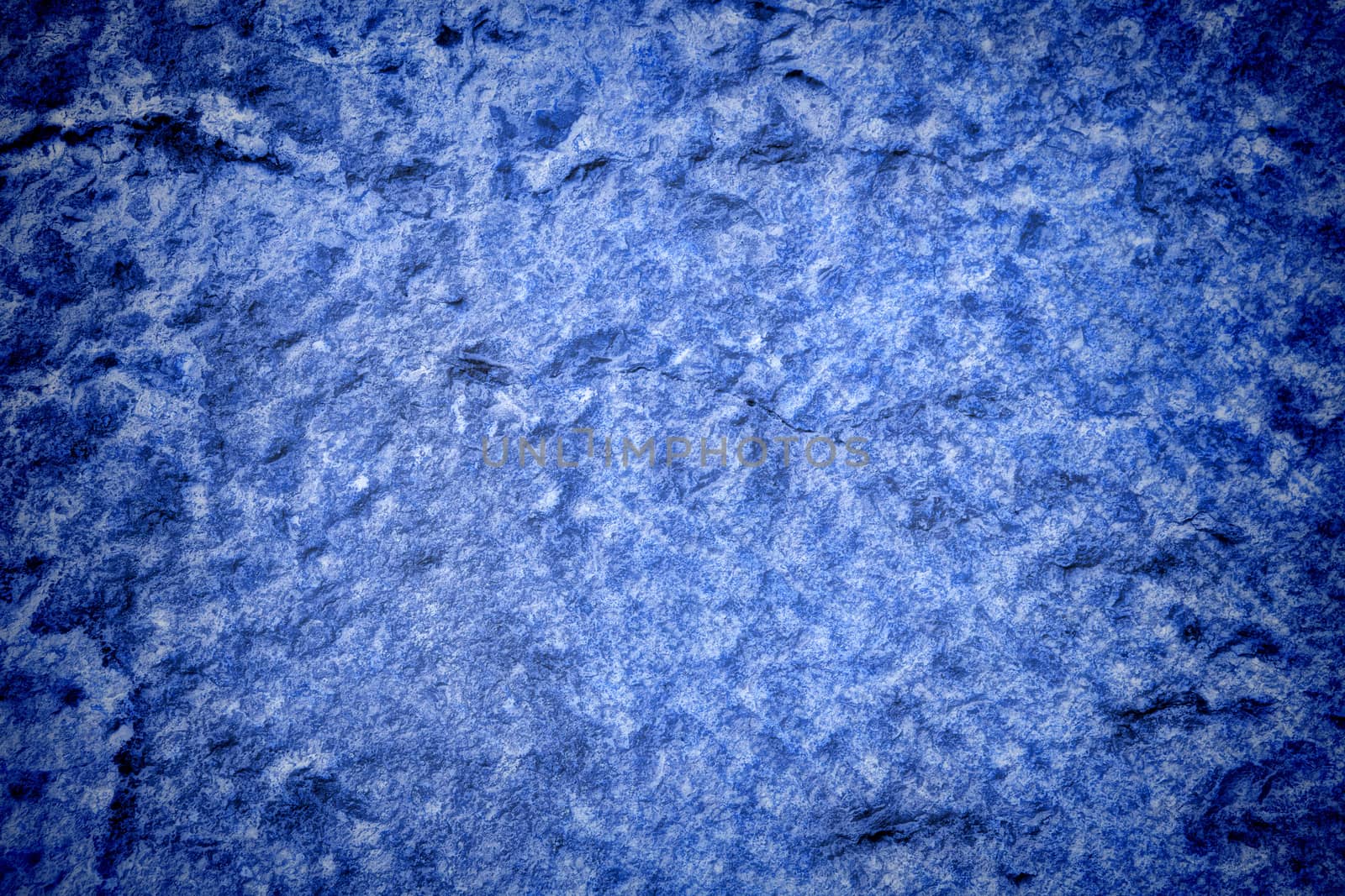 Vignetted stone wall background with lots of texture