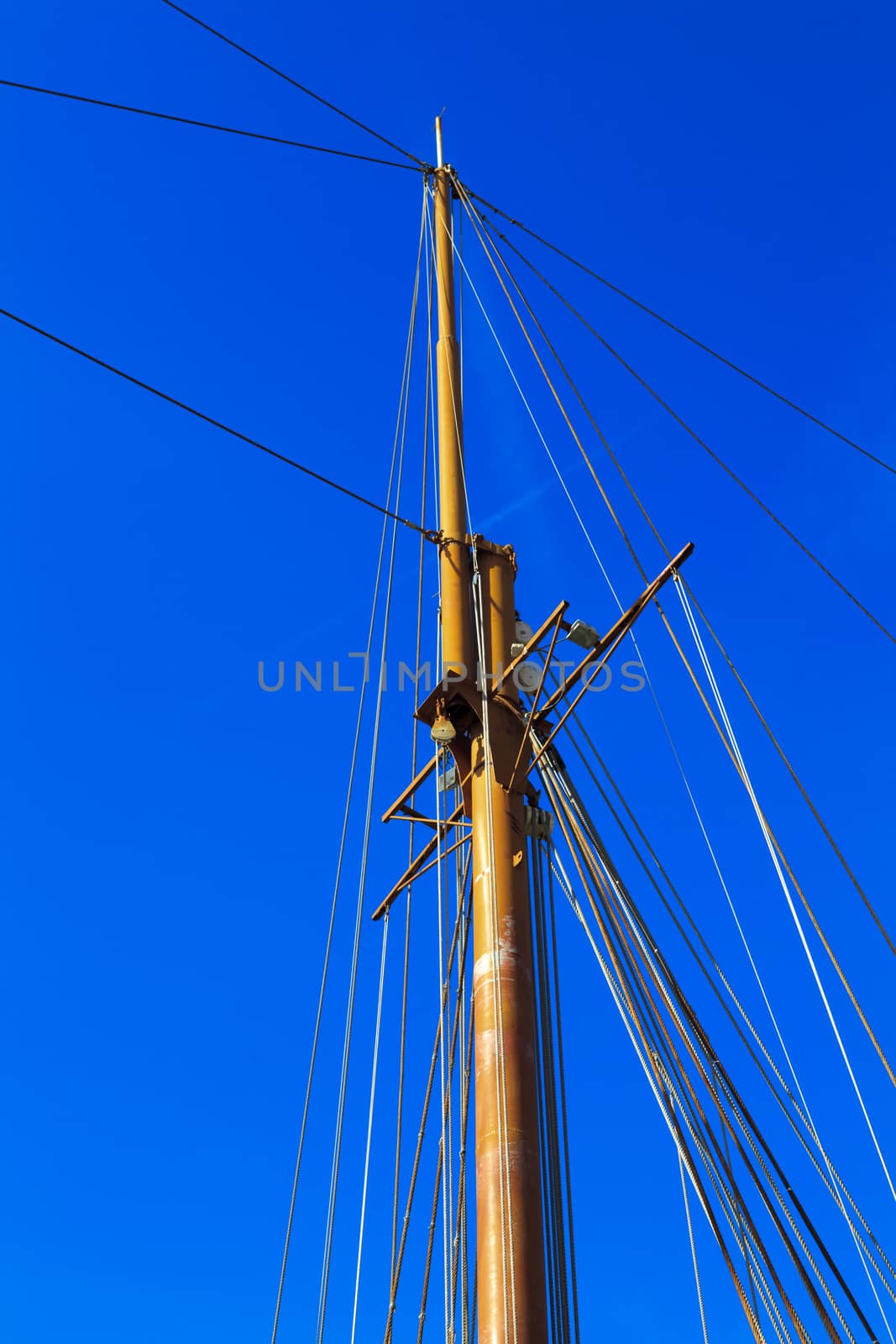 Yacht mast against blue summer sky