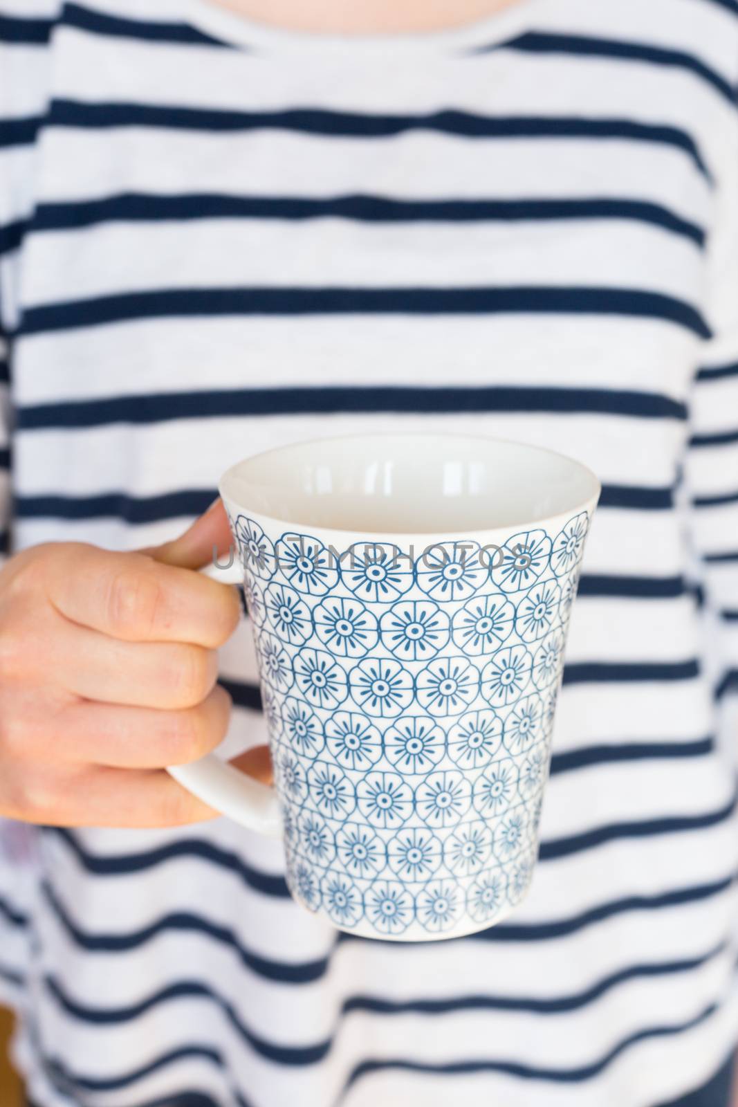 Girl or woman holding coffee or tea cup