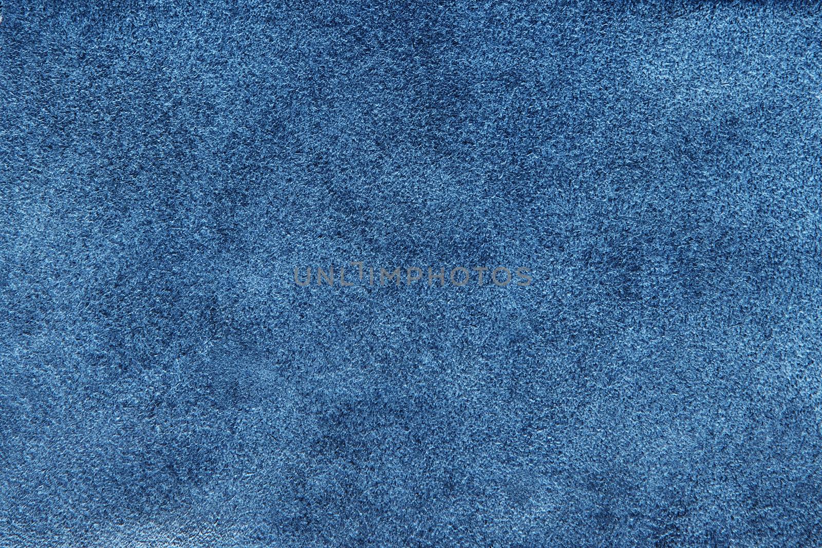 Blue suede soft leather as texture background. Old leather. Navy chamois texture. Fluffy and soft shammy-leather. Close up shammy leather texture