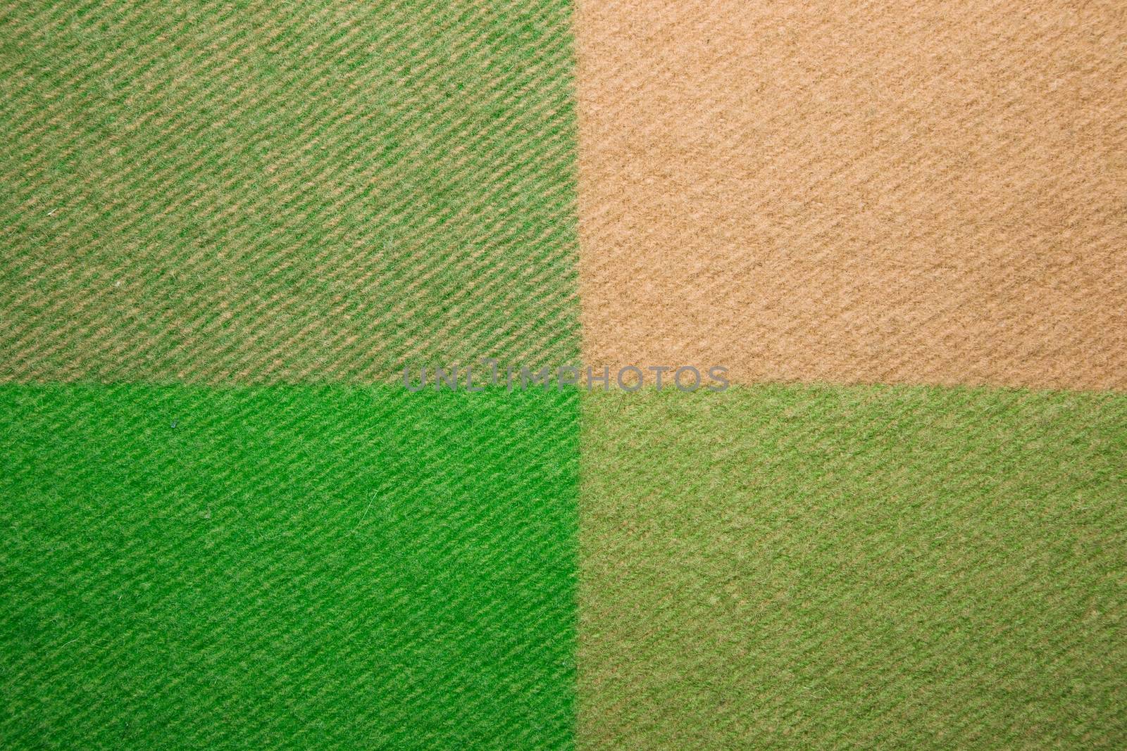 Soft and warm folded alpaca wool blanket. Green and beige wool plaid texture macro shot. Wool plaid texture Wool blanket