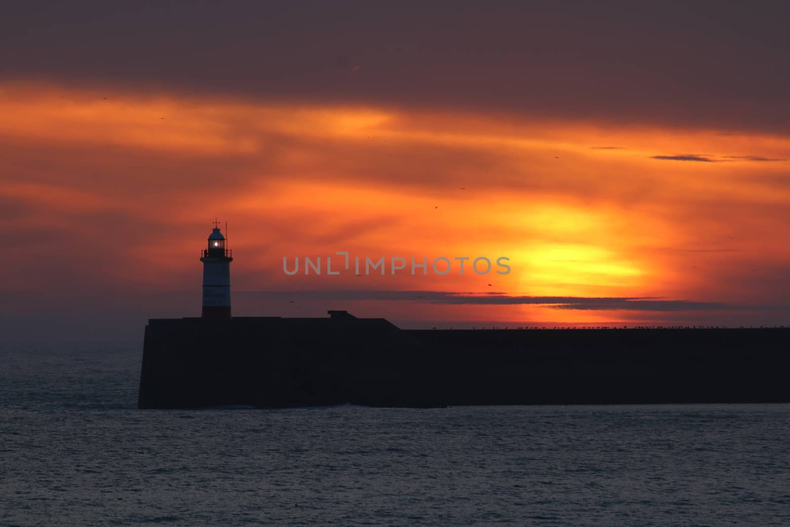 Sunset with Newhaven Lighthouse in East Sussex.