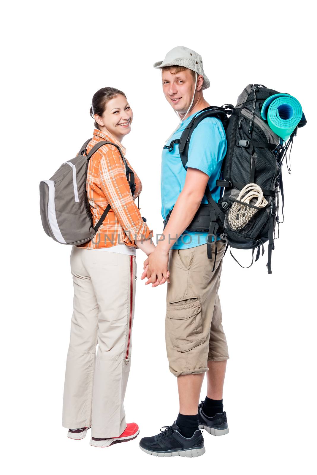 Happy couple with backpacks holding hands in studio on white bac by kosmsos111