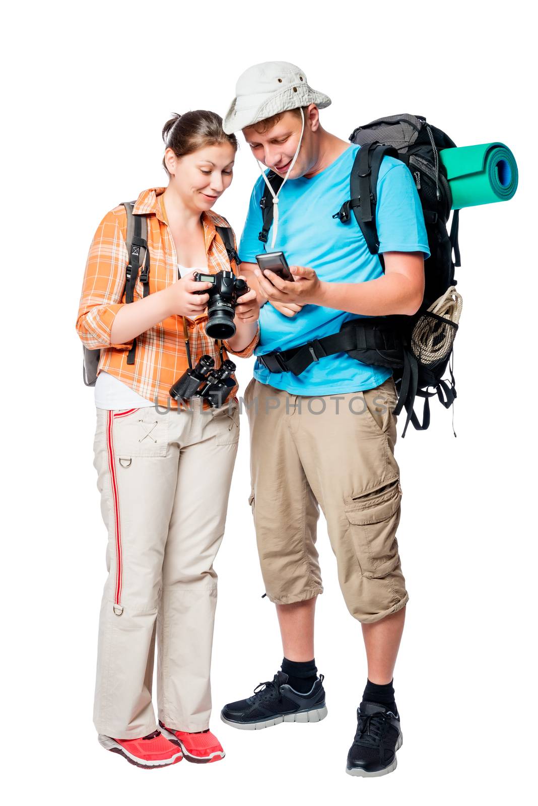 Active tourists with backpacks view photos on camera on white background