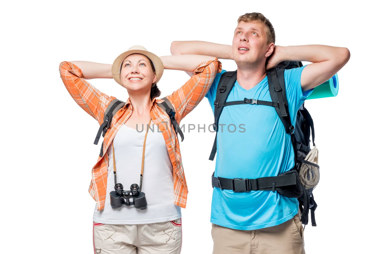 Relaxing couple of young tourists with backpacks on a white background