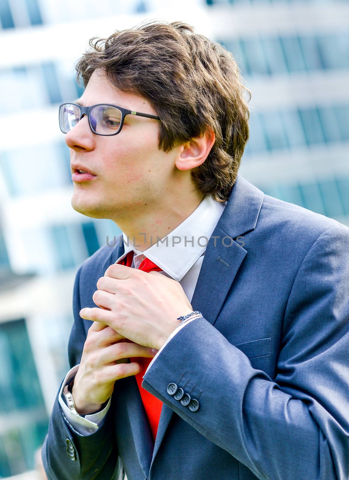 dynamic young leader adjust his tie before a job interview or business meeting