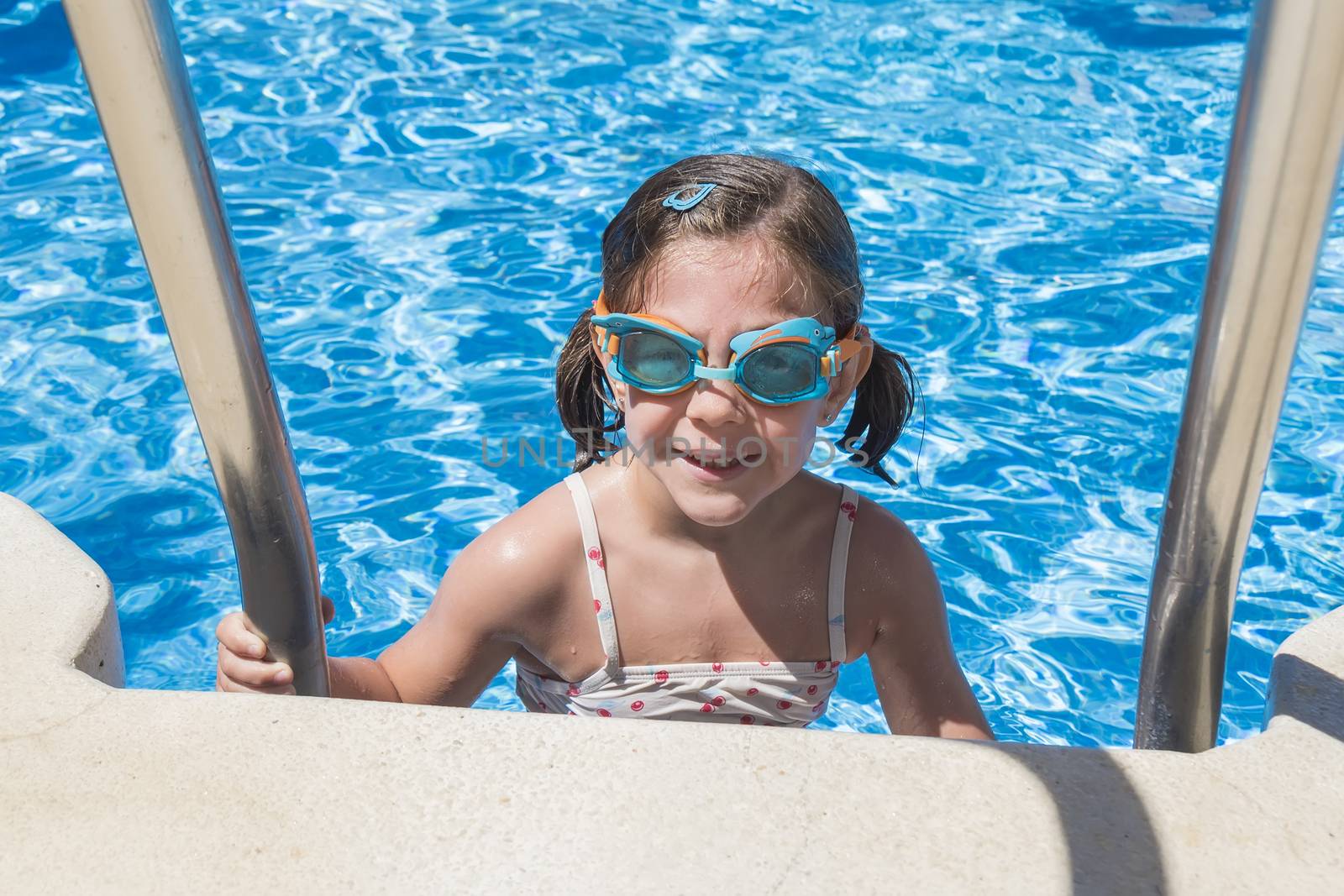 Smiling girl enjoying the pool in summer by max8xam