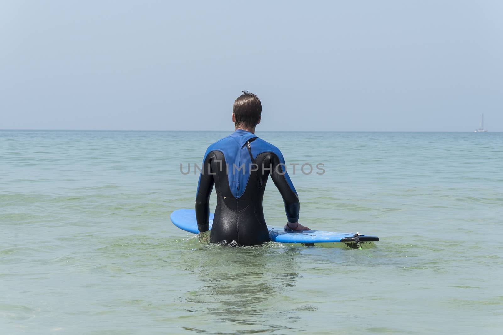 Young boy surfing in the sea