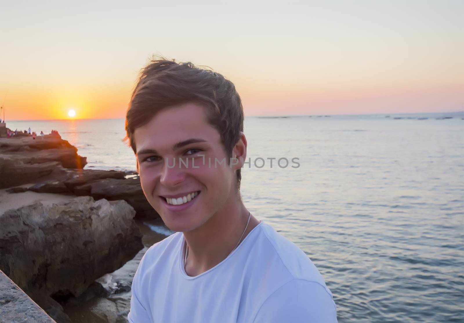 Handsome male model smiling after sunset