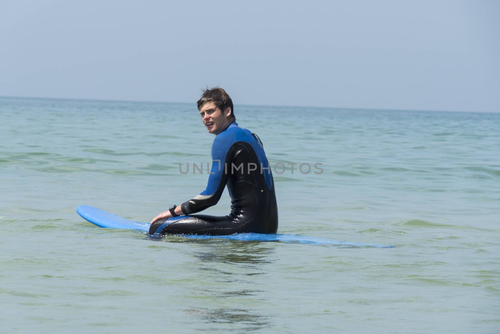 Young boy surfing in the sea