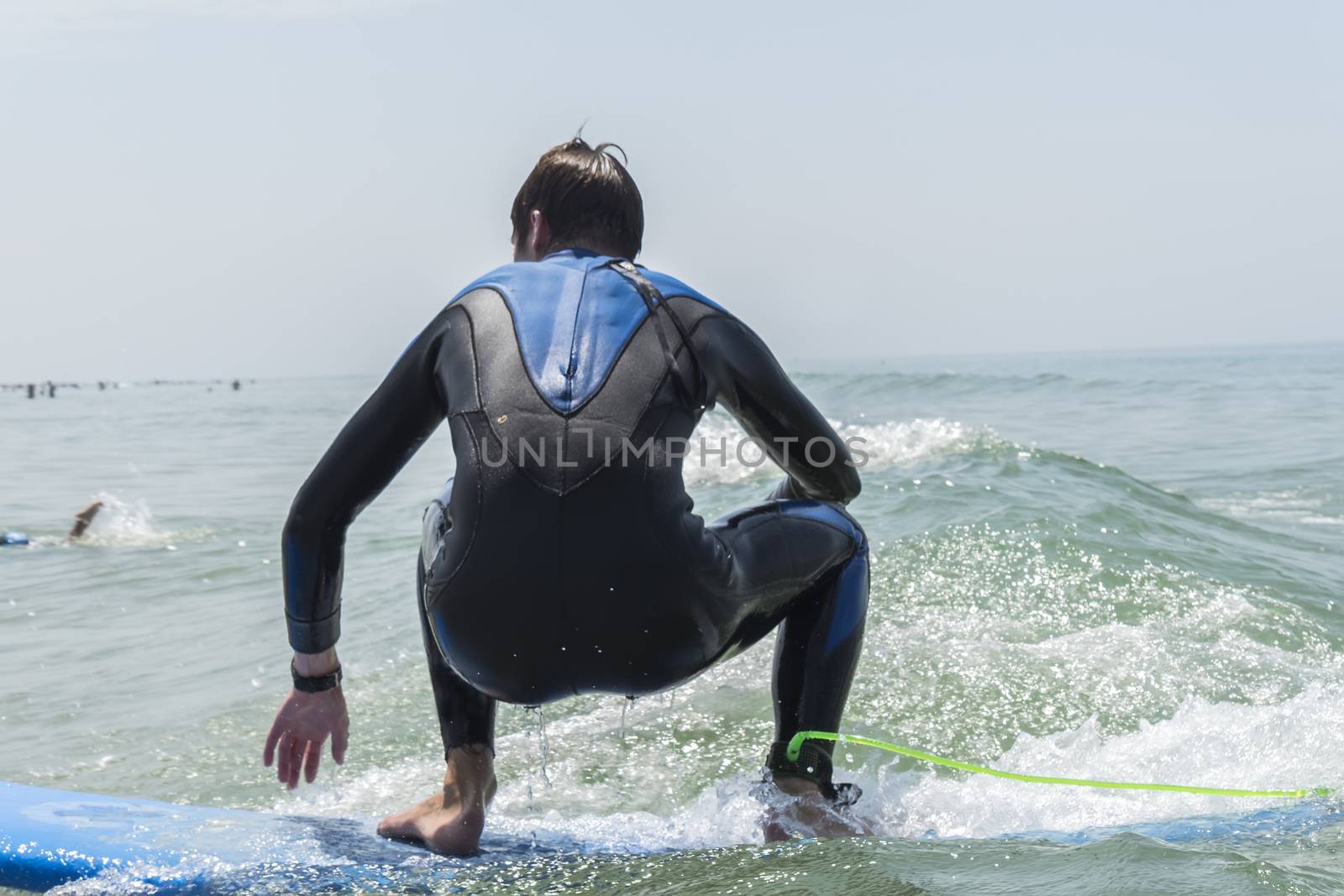 Young boy surfing in the sea by max8xam