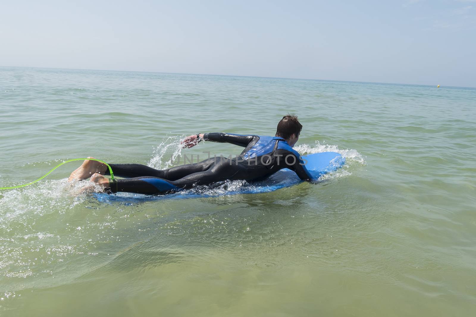 Young boy surfing in the sea