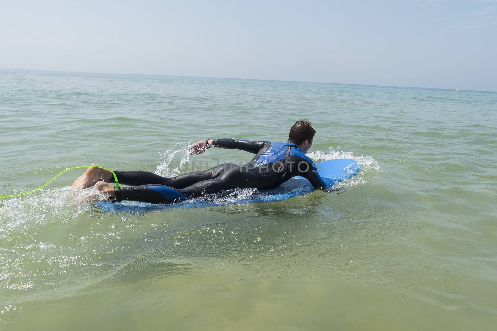 Young boy surfing in the sea by max8xam