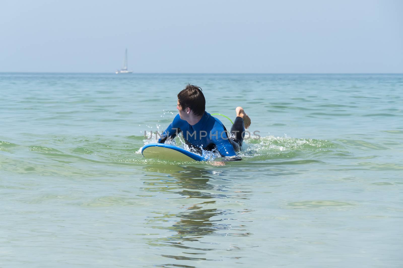 Young boy surfing in the sea by max8xam