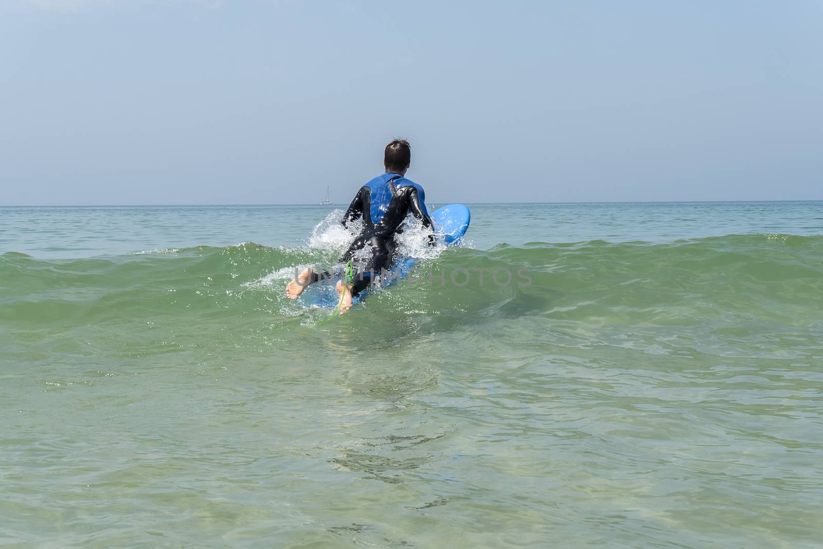 Young boy surfing in the sea