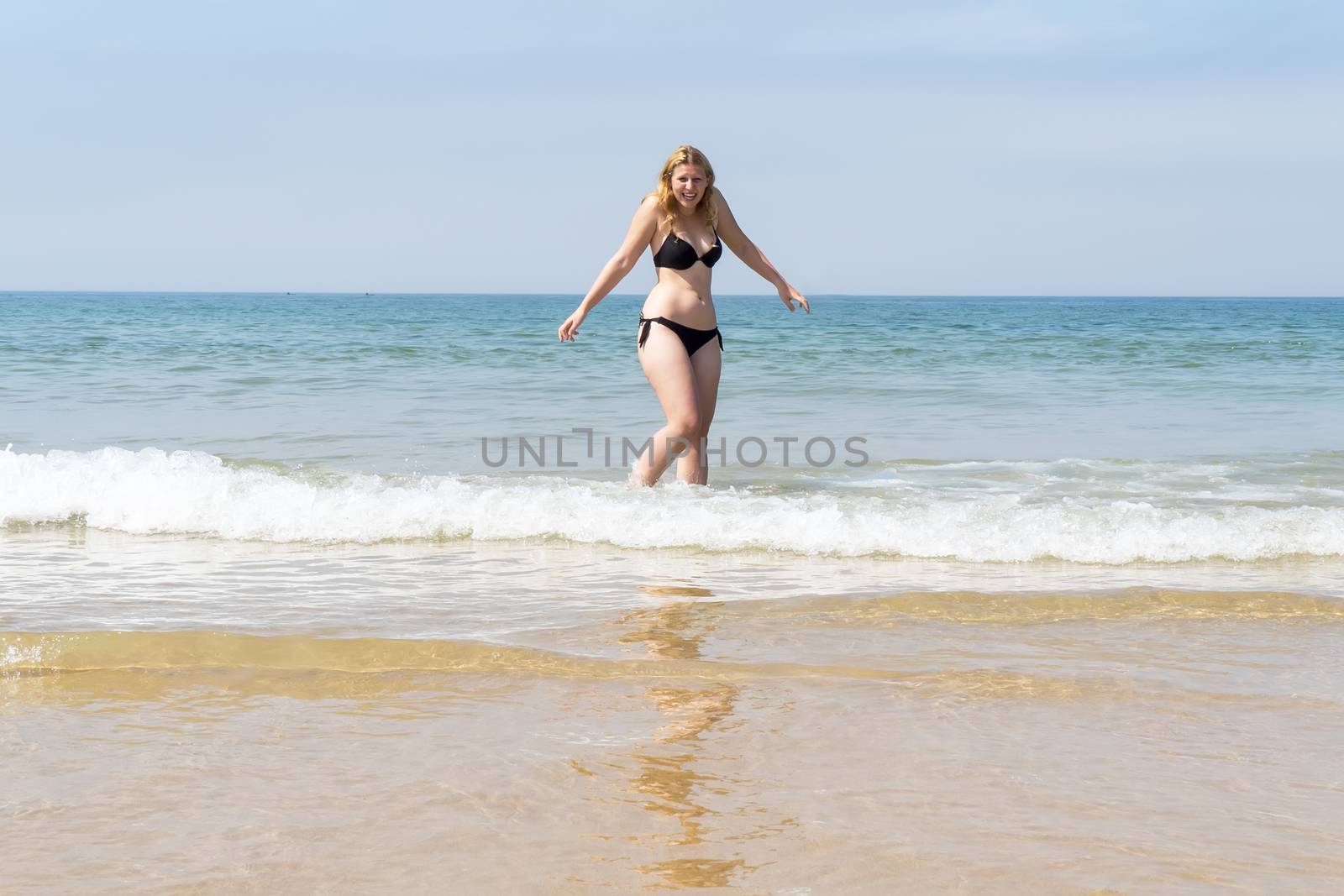 Beautiful young girl enjoying the beach in summer