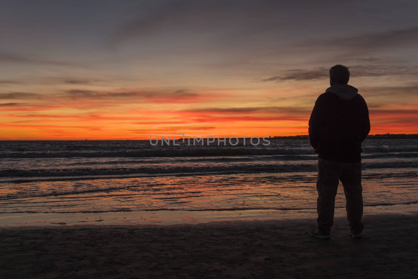 Silhouette of man on a beautiful sunset on the beach