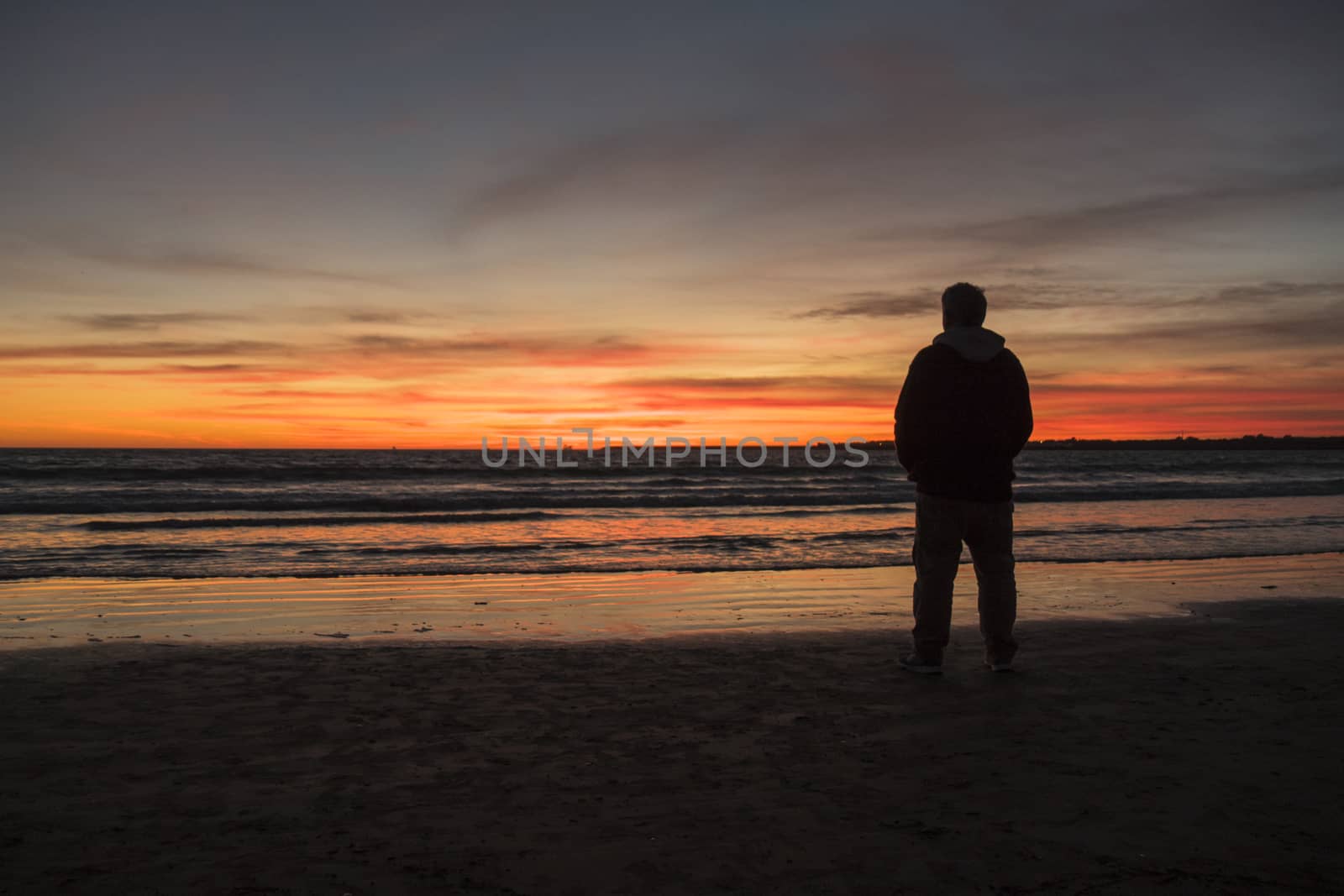 Silhouette of man on a beautiful sunset on the beach