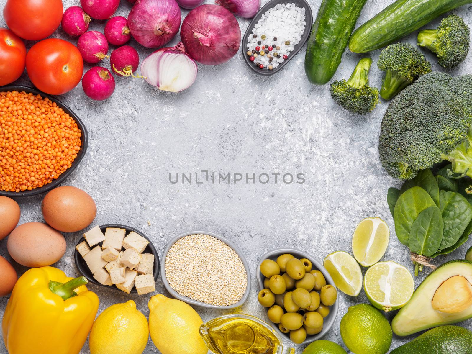 Colorful food background. Vegan food ingredients with copy space. Cereals and vegetables on gray concrete background. Healthy eating concept