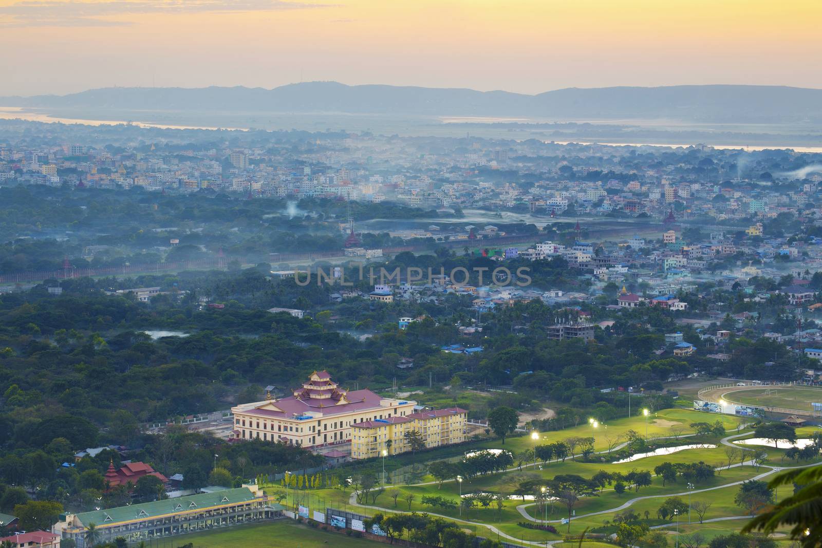 Mandalay with lake mountains, temples and pagodas seen from mandalay hill at sunset, Burma.